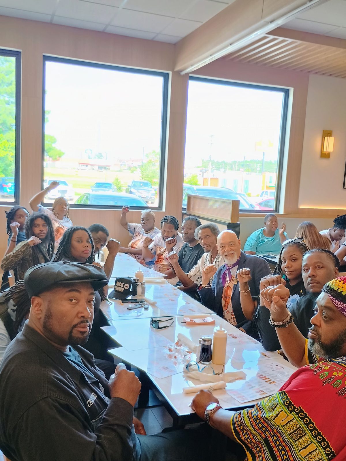 Community members sharing a meal at a town hall