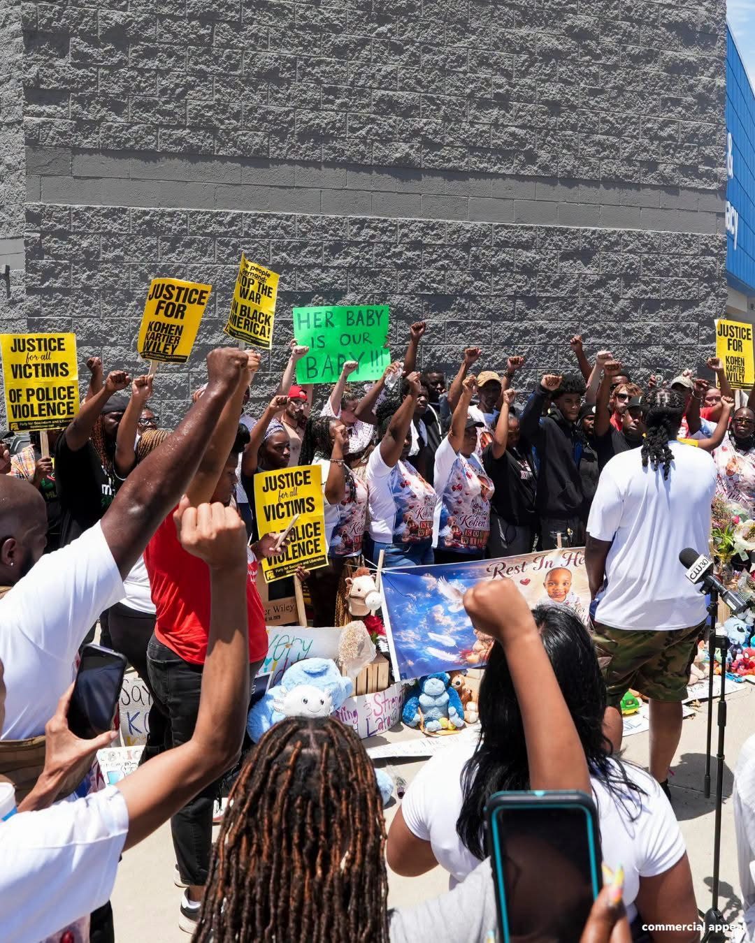 Crowd raising Justice for Kohen signs and portraits